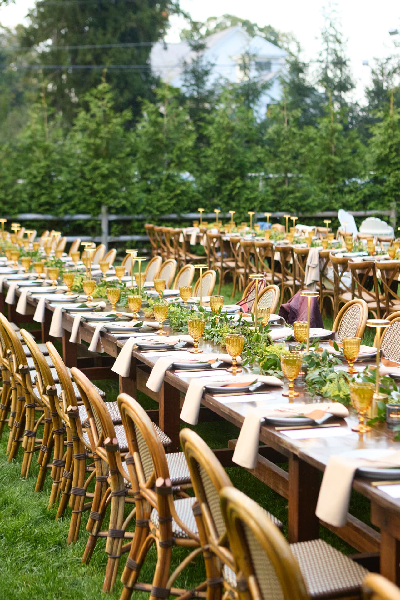 Amber glasses and greenery lining the dinner tables