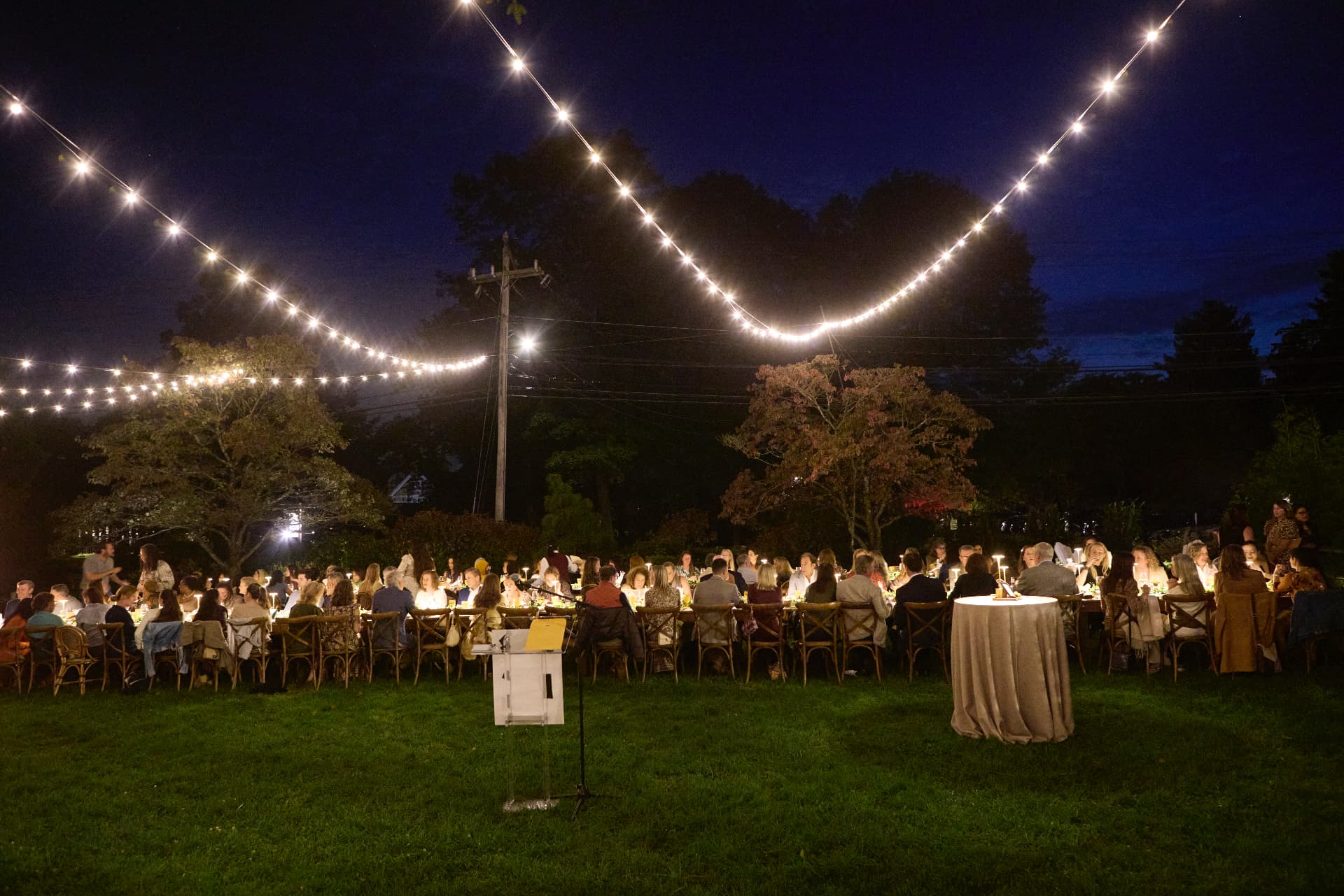 A wide view of the candlelit garden dinner