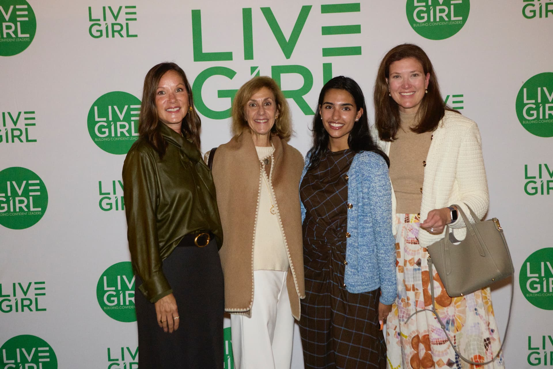 JPMorgan Chase's Laura Davis and guests at the LiveGirl step-and-repeat