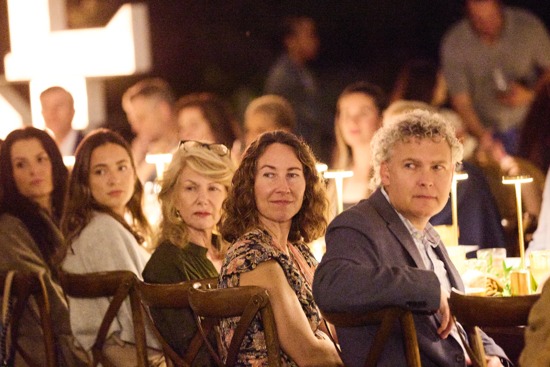 Guests listening at dinner
