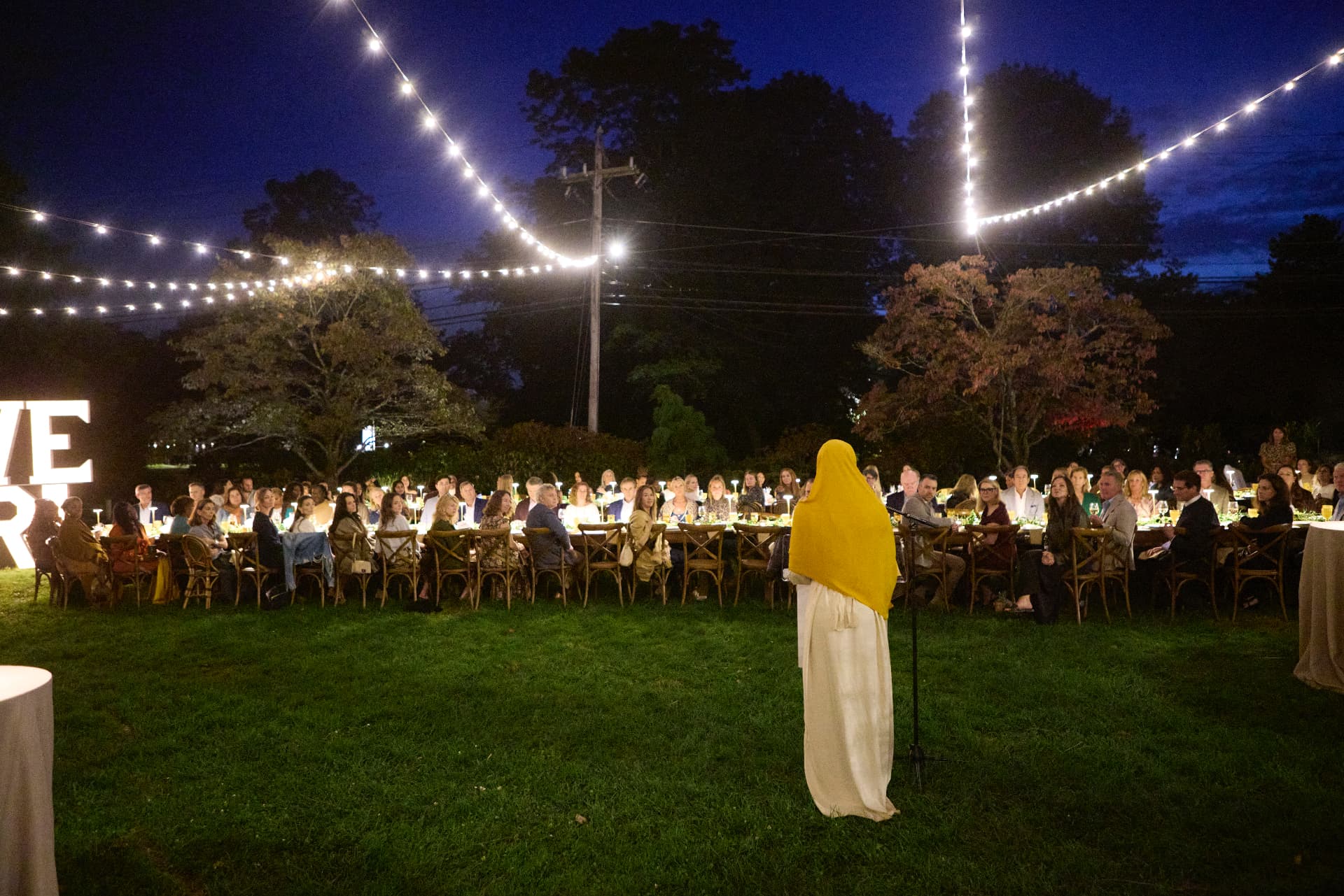 Secora Chambers reciting Uplifted Legacy to the audience on the lawn