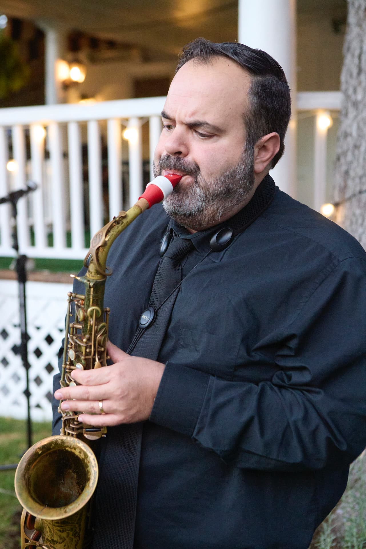 A saxophonist performing during the garden reception