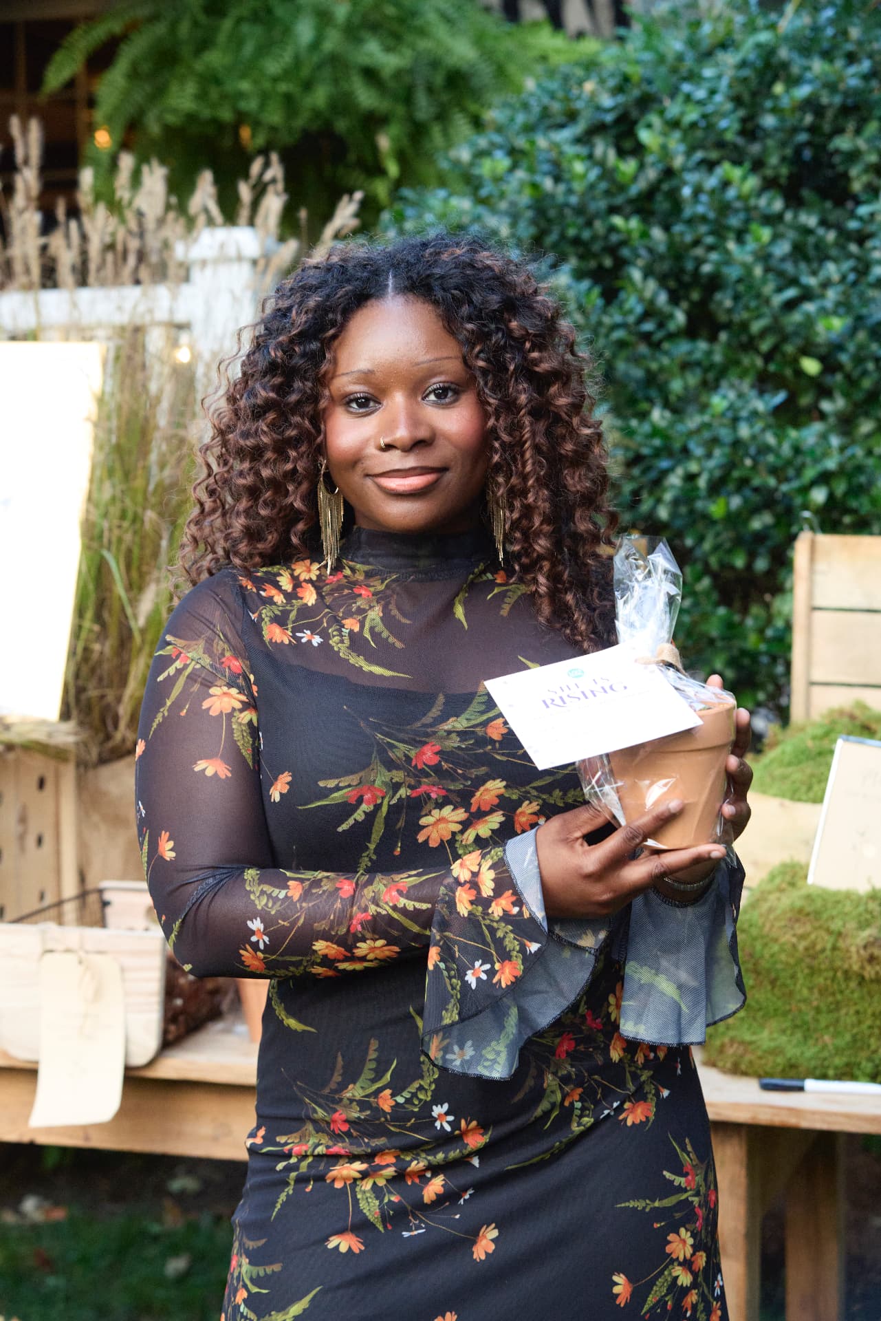A LiveGirl volunteer at the Bulb Bar with a potted-plant keepsake