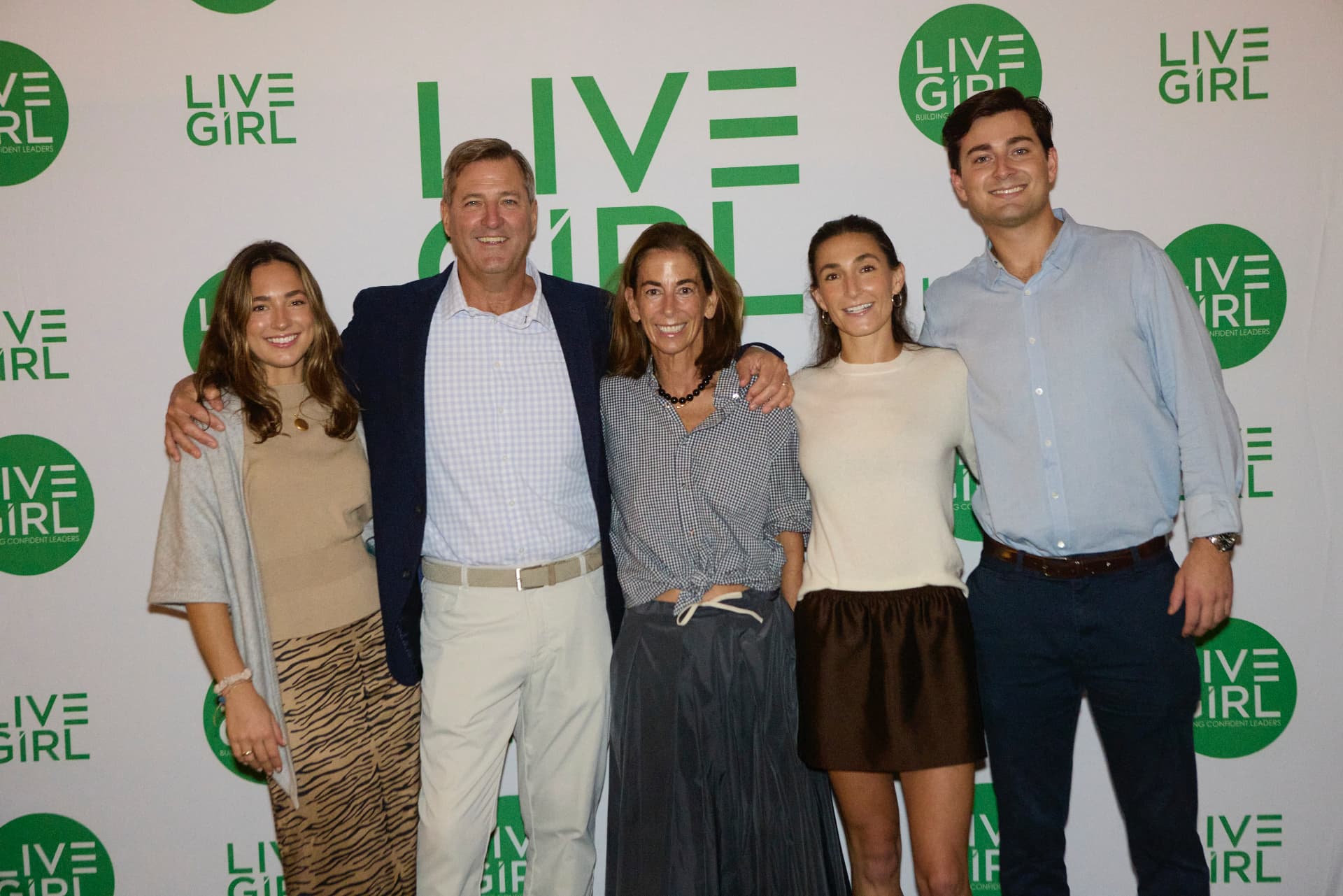 A family gathered at the LiveGirl step-and-repeat