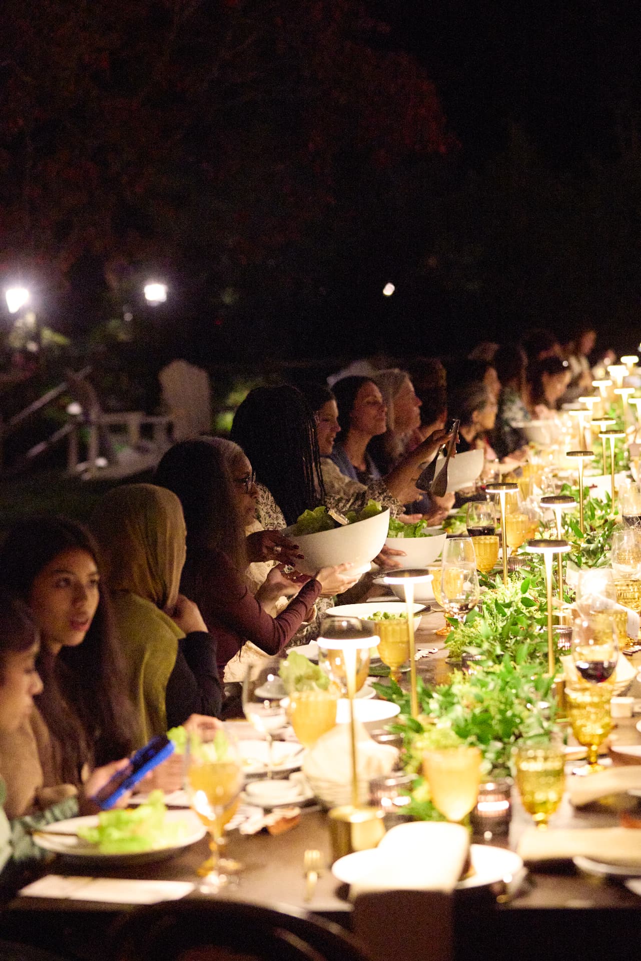 Guests passing food along the family-style dinner table