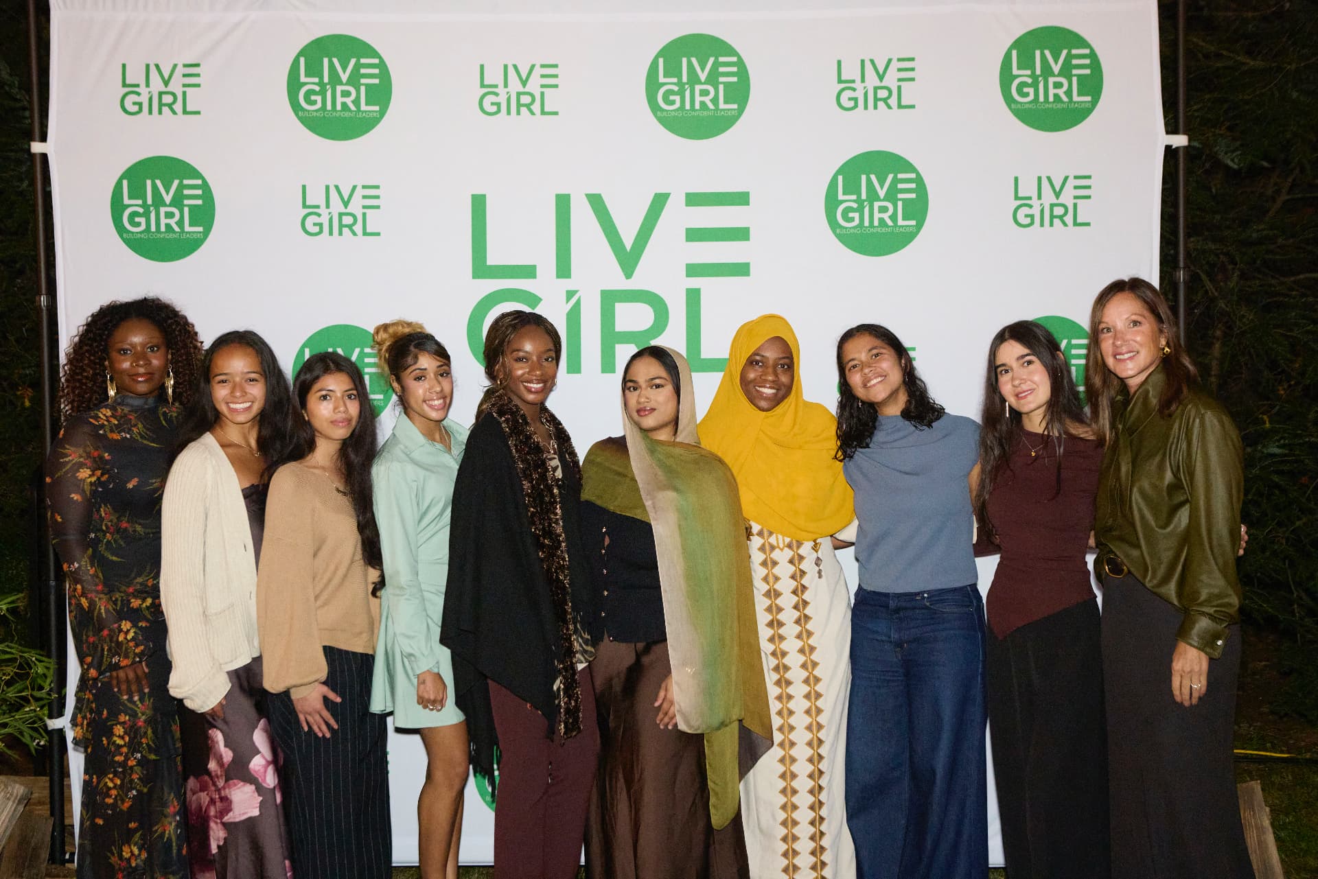 LiveGirl students and alumni at the step-and-repeat