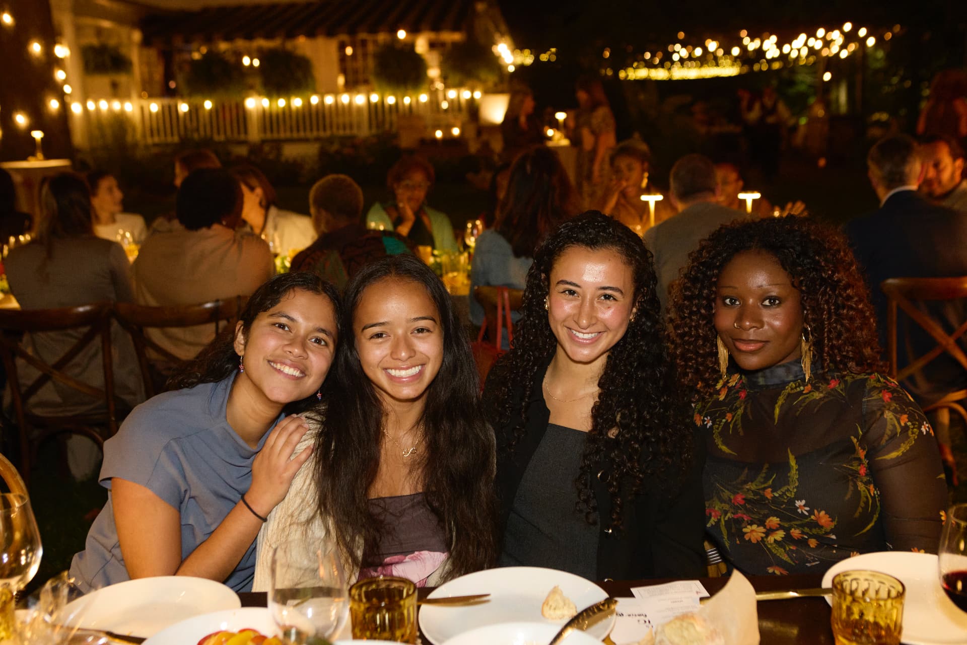 Four young guests gathered around their dinner table