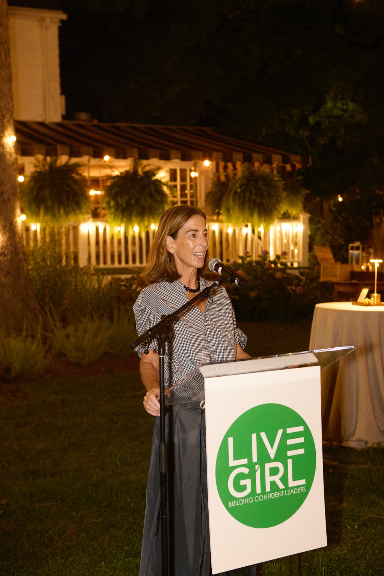 Claire O'Hare speaking at the LiveGirl podium as the 2026 Changemaker of the Year