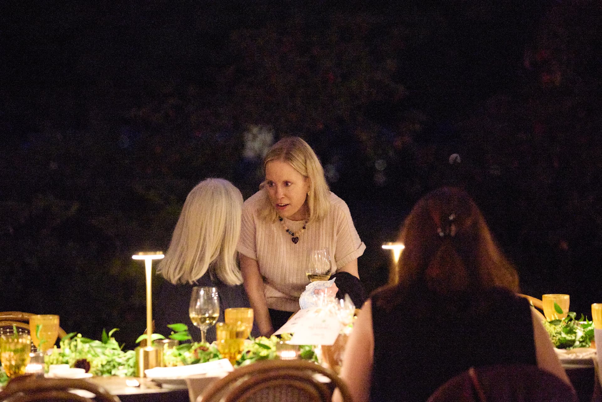Conversation around a candlelit dinner table