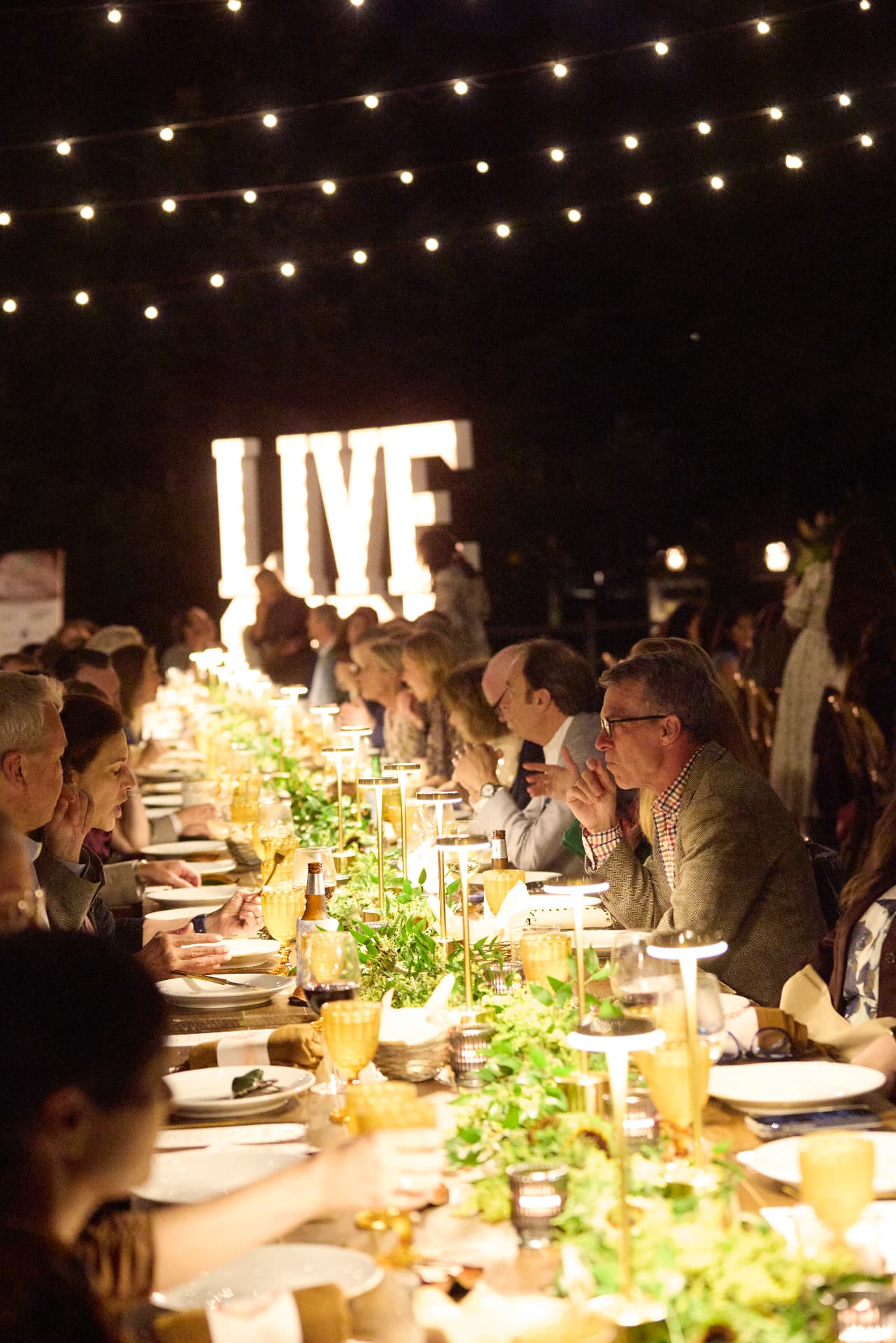 Dinner beneath the lights and the glowing LIVE letters