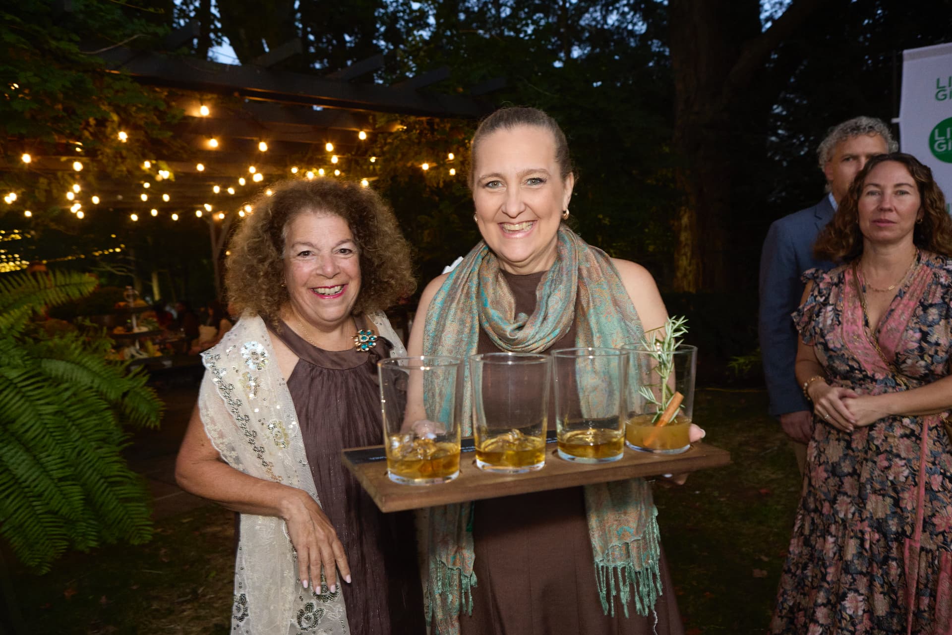 Guests raising a tasting flight in the garden