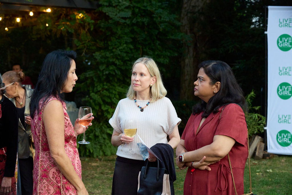 Friends catching up over a glass of wine at the welcome reception