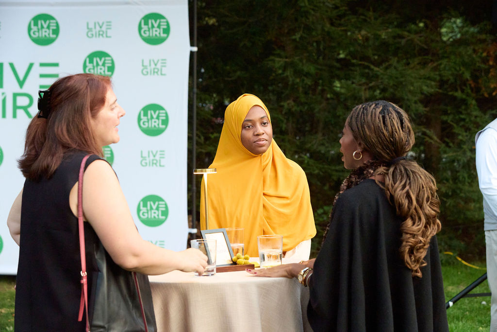Secora Chambers with emcee Claire Ayoub and Schebania Philemon at a garden table